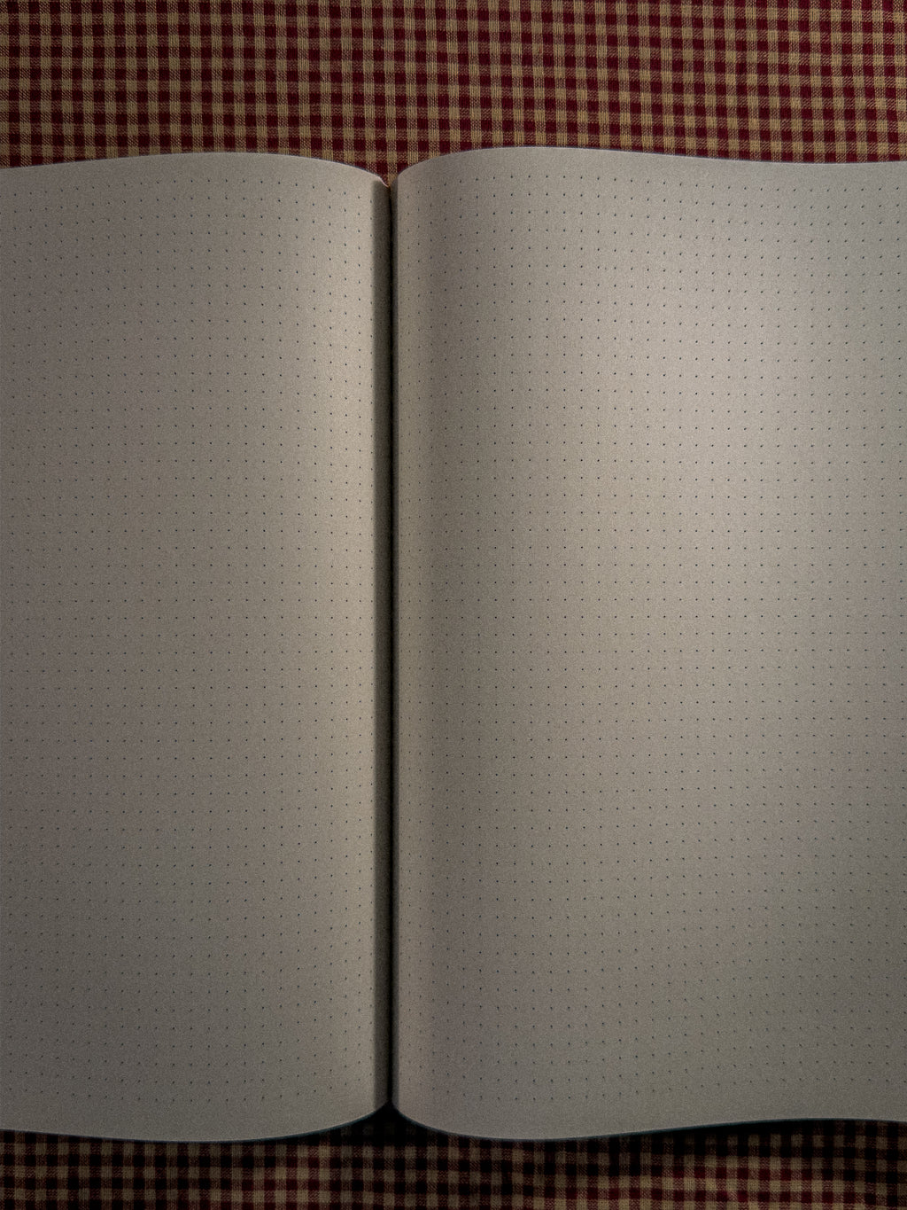 A brown a4 desk sized paper notebook sized at 11" x 8.5" laying open