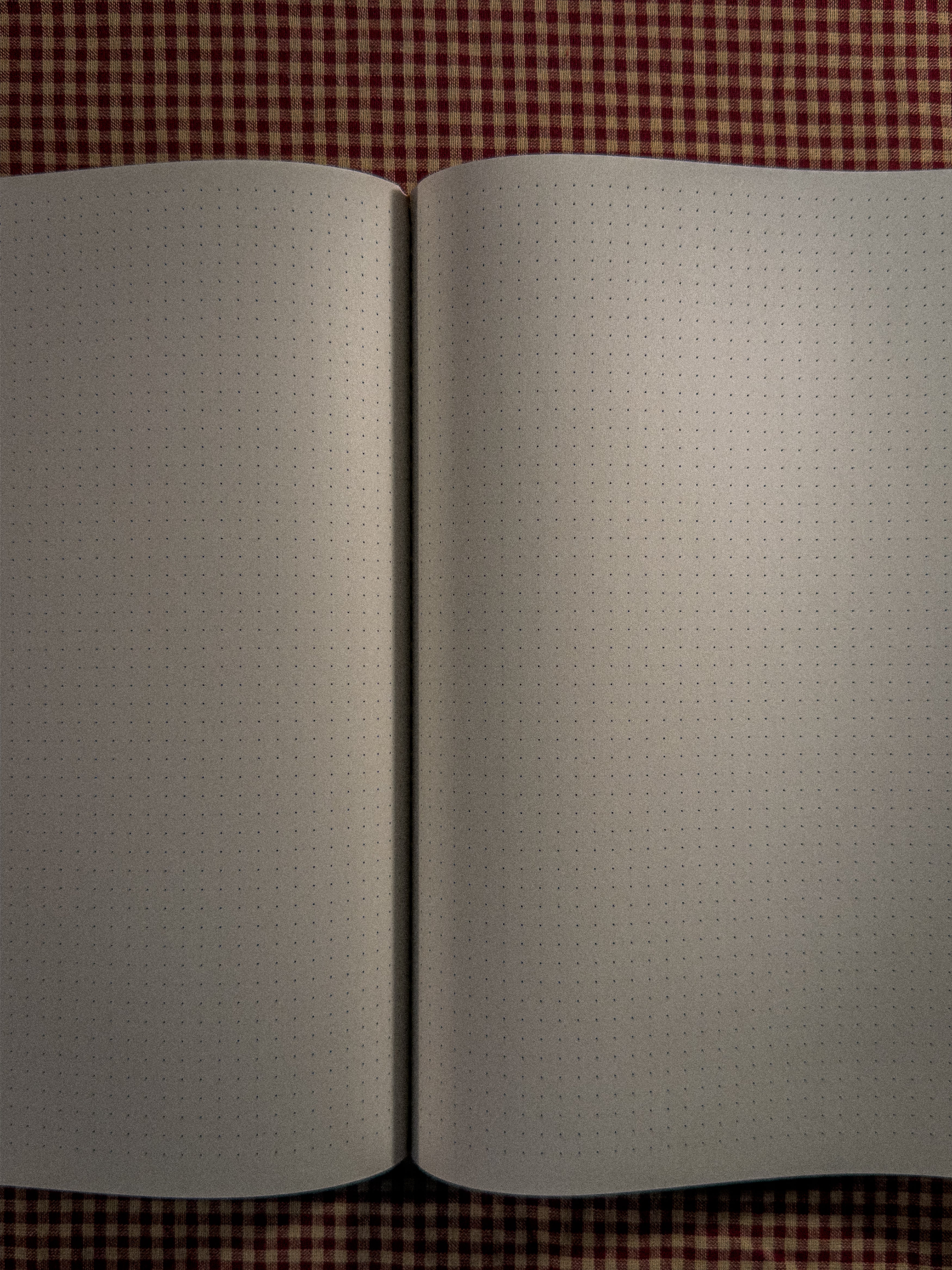 A brown a4 desk sized paper notebook sized at 11" x 8.5" laying open