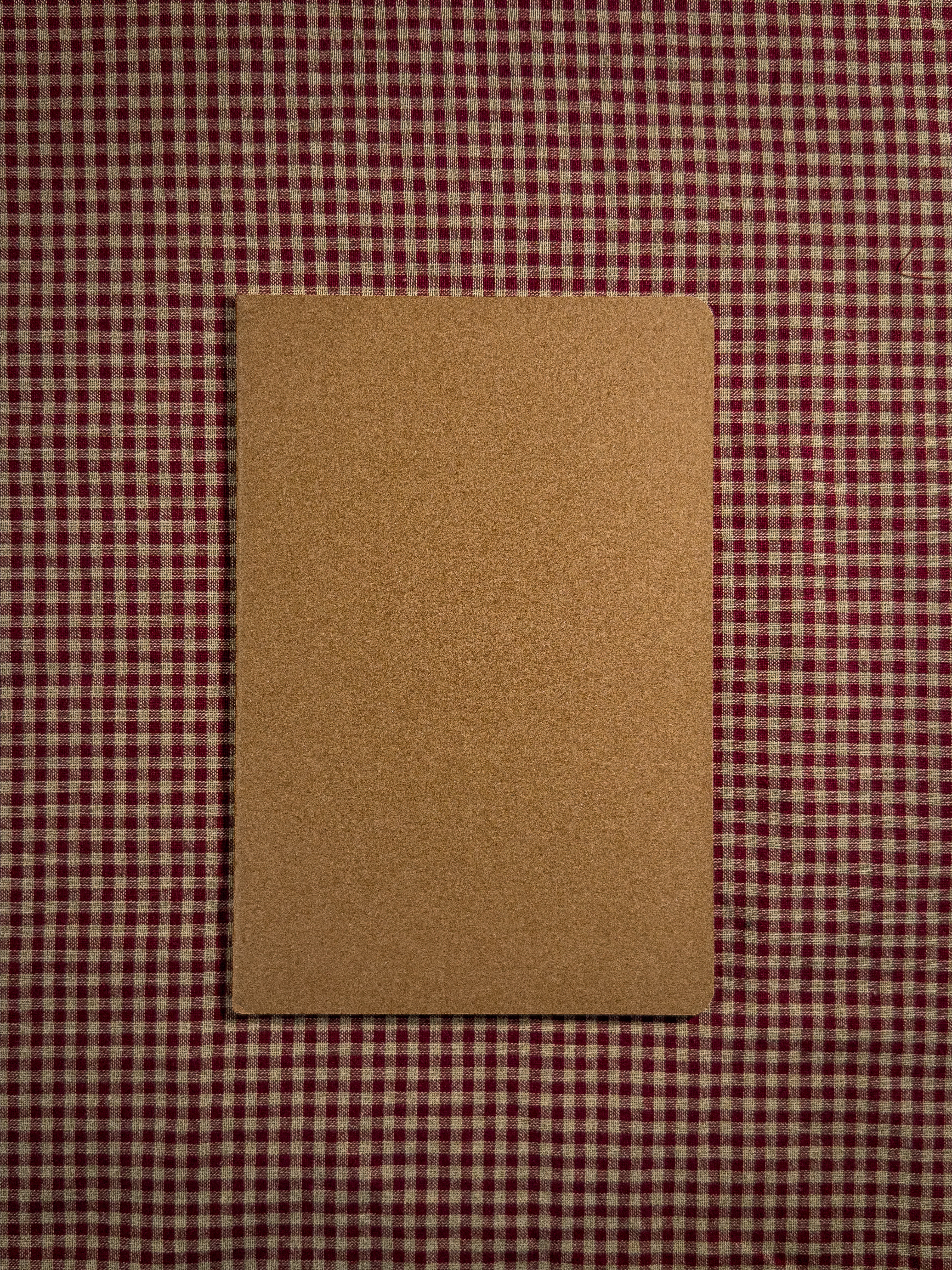 A brown book bag sized paper notebook sized at 8.3" x 5.5" 