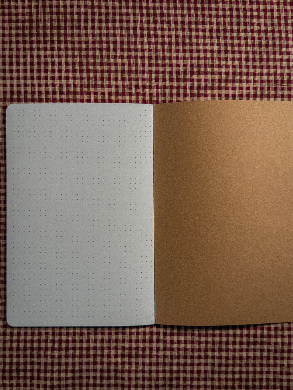 A brown book bag sized paper notebook sized at 8.3" x 5.5" open flat