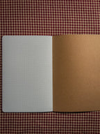 A brown book bag sized paper notebook sized at 8.3" x 5.5" open flat