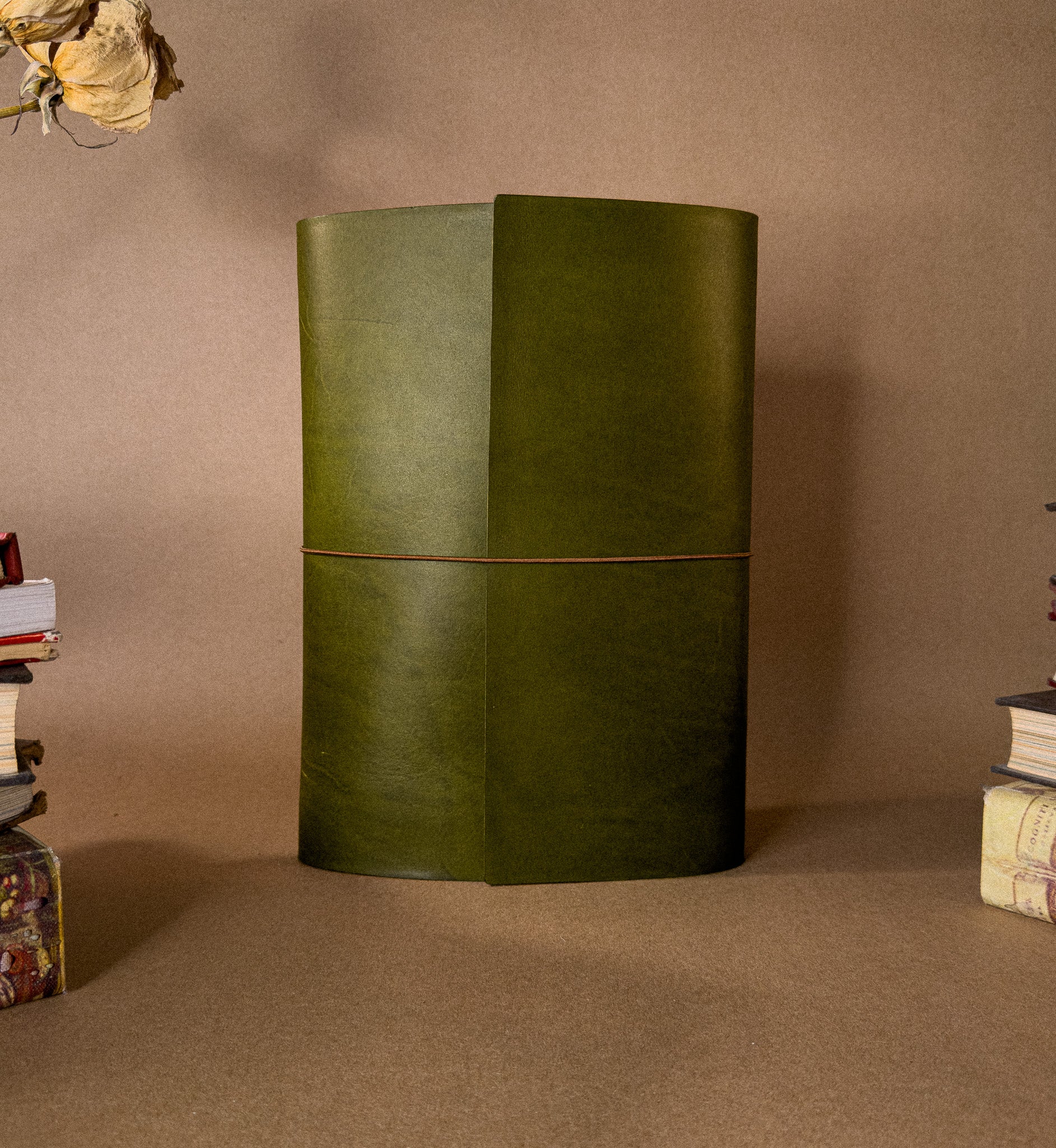 Large desk sized green leather journal on a brown background